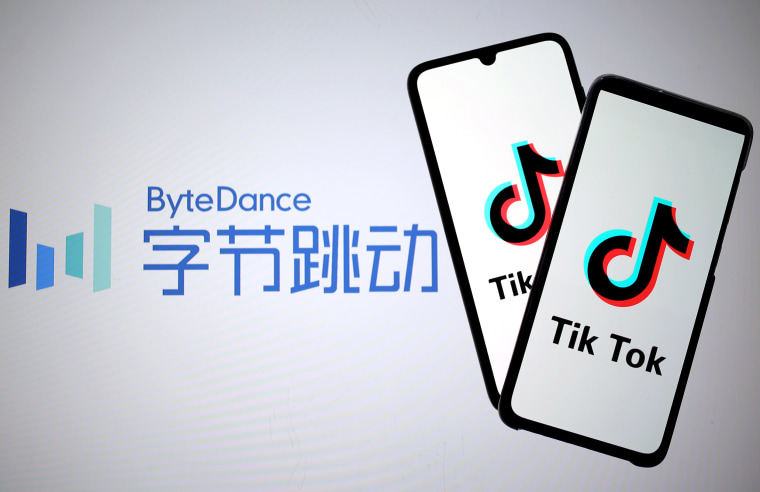 Image: Tik Tok logos are seen on smartphones in front of a displayed ByteDance logo,